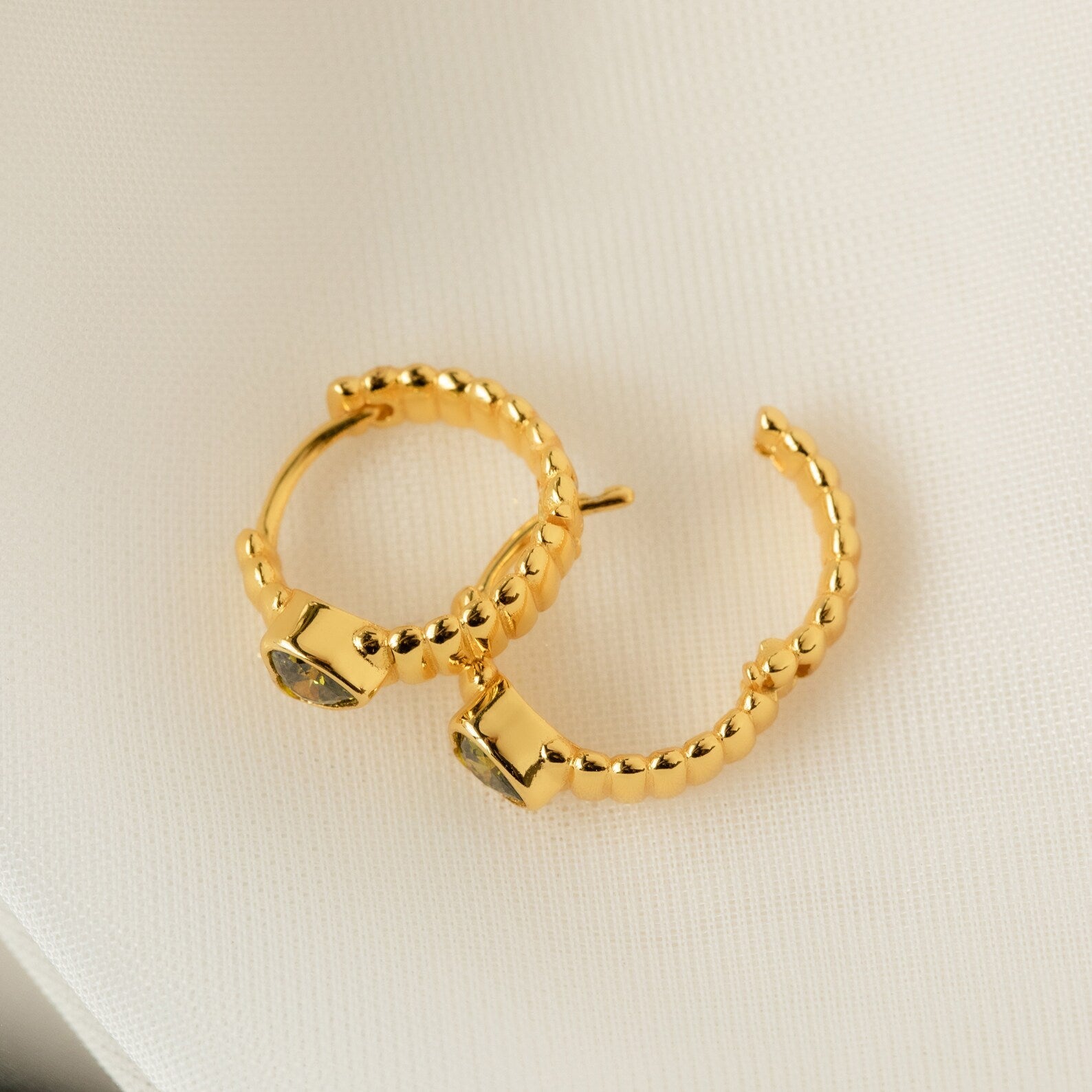 Unique Elegance: Peridot Heart Huggie Earrings